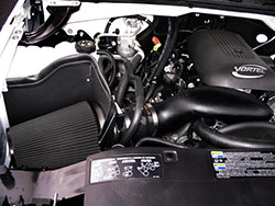 The AIRAID cold air dam system keeps hot engine air out of the intake by sealing the filter with aluminum panels and weatherstripping against the underside of the hood.

