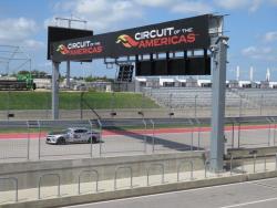 Shot of Jordan Priestley on the COTA Road Course just under the banner